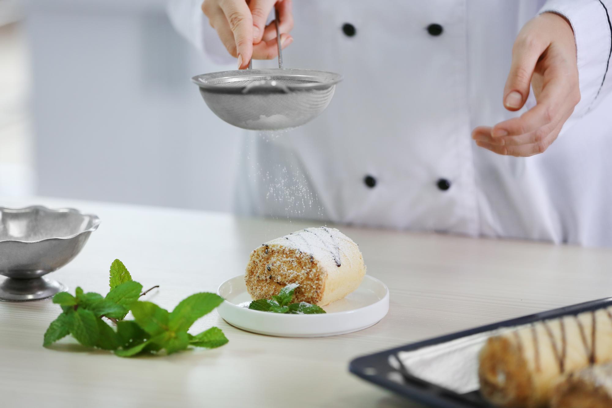 Chef plating dessert with micro herbs