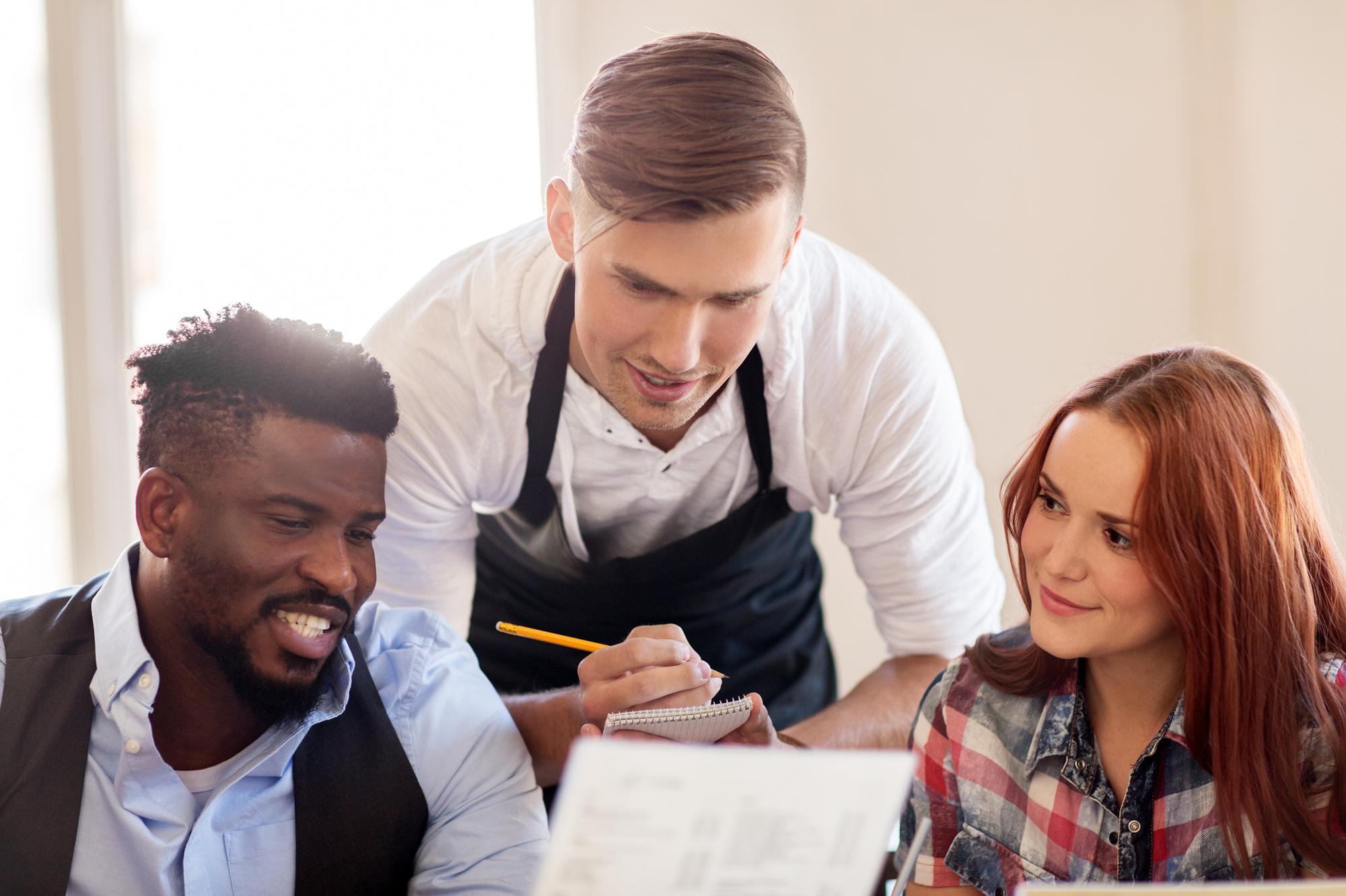 Consultation session with chefs reviewing a menu